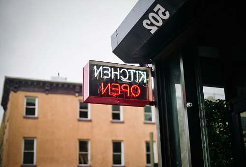 neon white and red neon lighted kitchen open signage during daytime williamsburg
